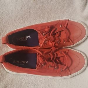 Red Sperry sneakers faded